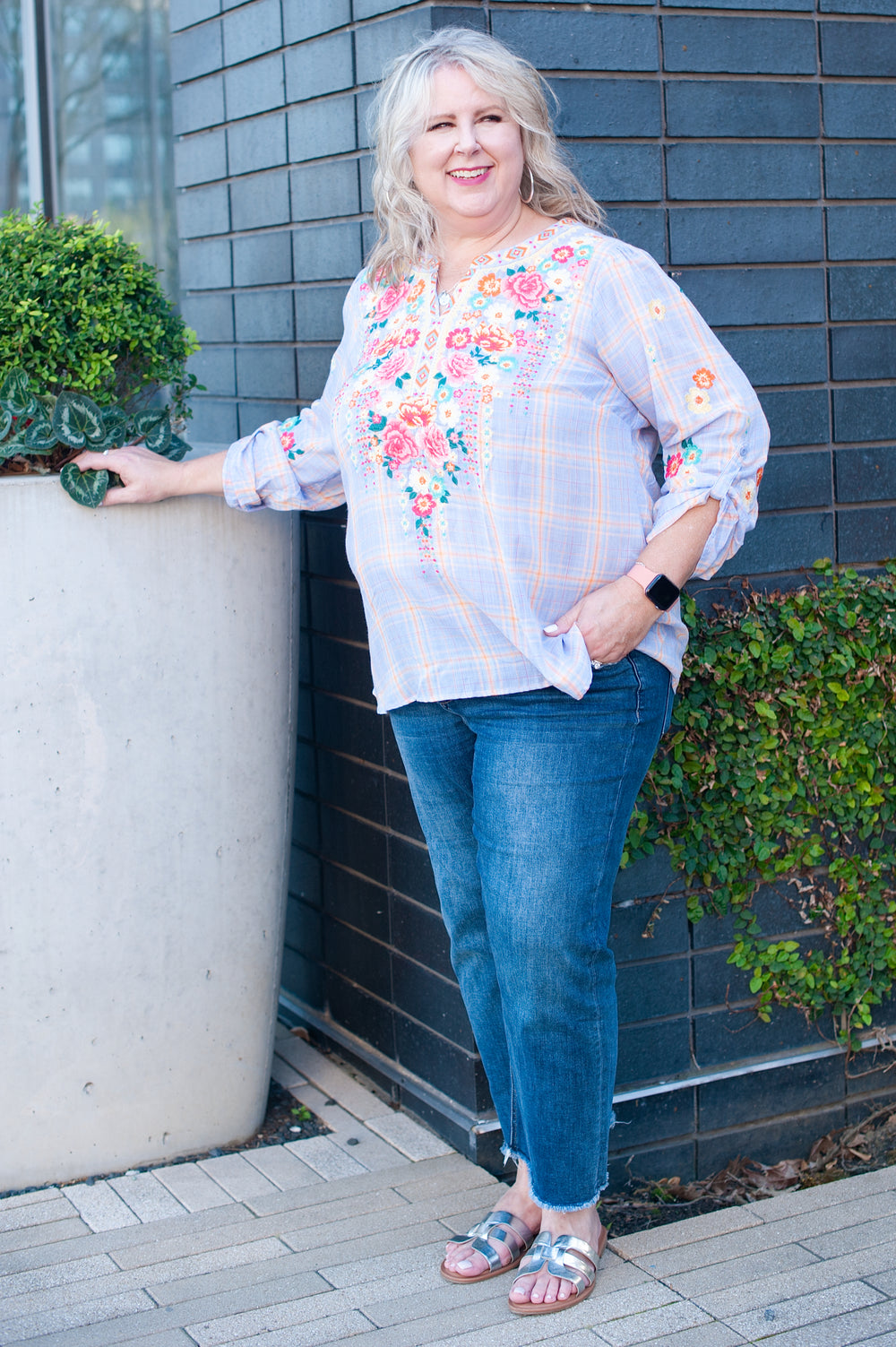 woman wearing a plaid top with floral details