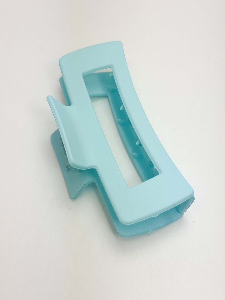 light blue rectangular hair clip on white background