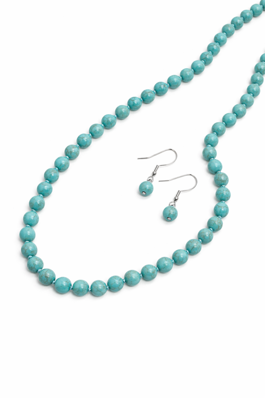 Turquoise bead necklace and earrings on a white background