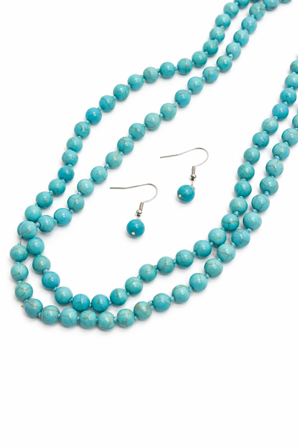 Turquoise beaded necklace and earrings on a white background