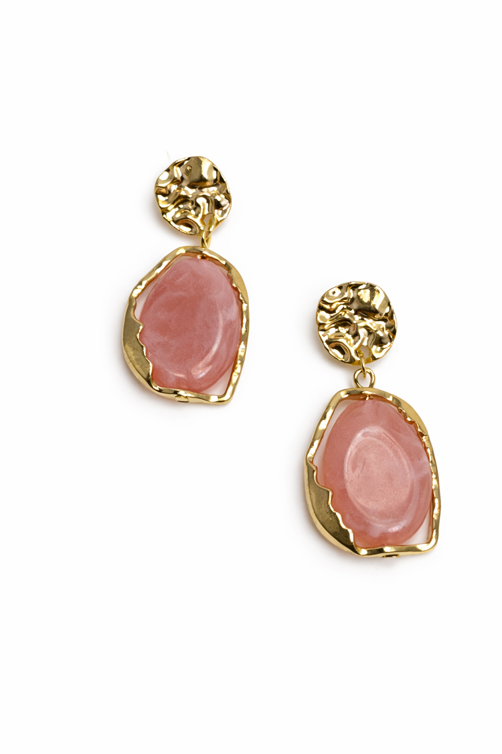 Pair of earrings with pink stone and gold frame on a white background