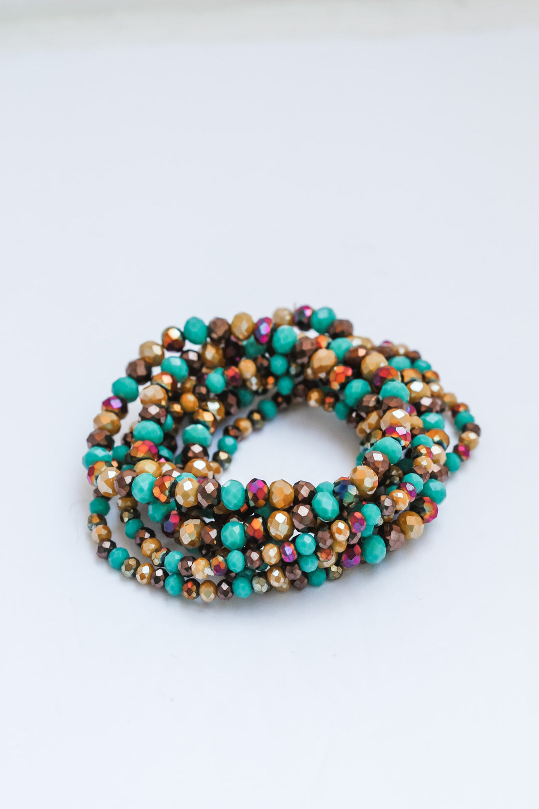 Multicolored beaded bracelet on a light gray background