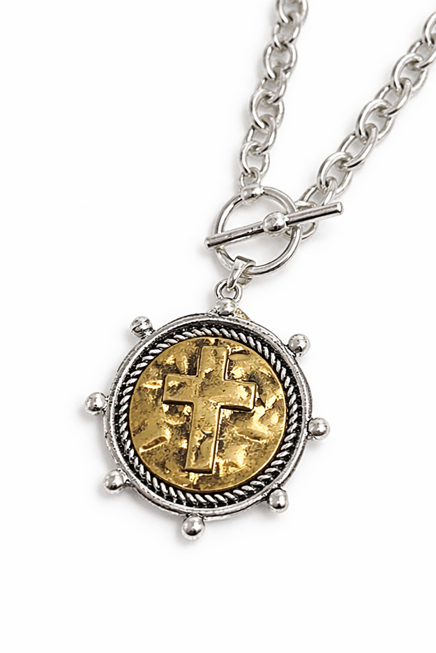 Necklace with a round pendant featuring gold and silver design on a white background
