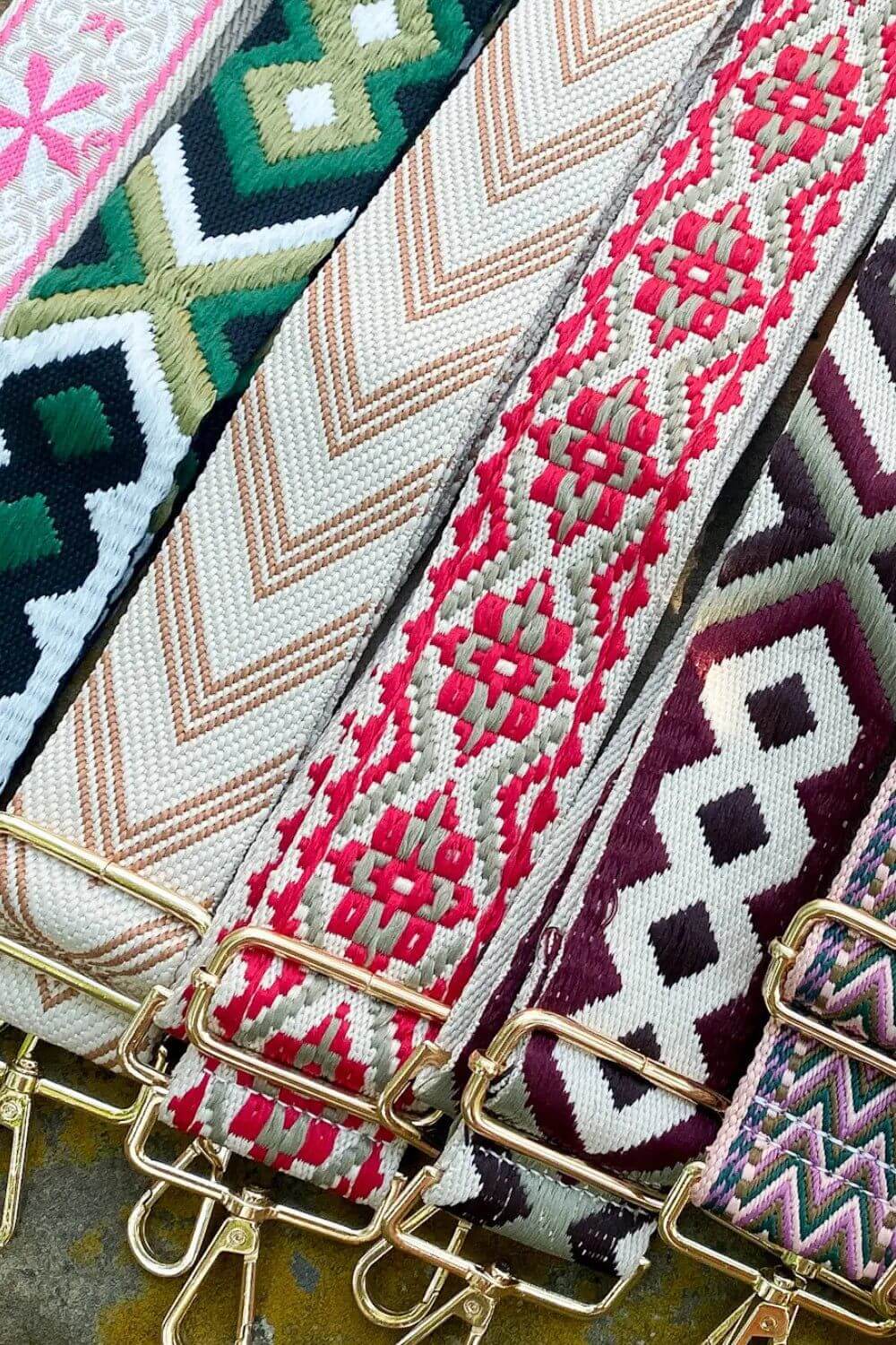 decorative purse straps laying flat in a row