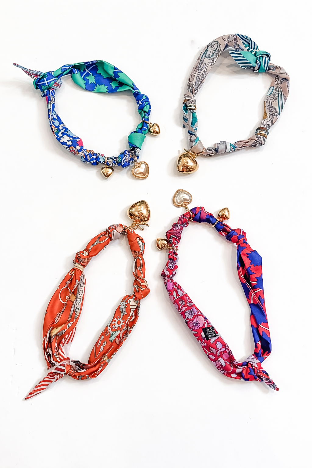 Four colorful headbands with decorative elements on a white background