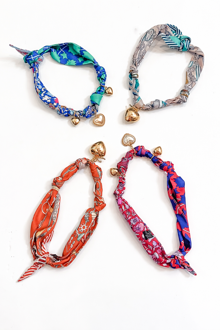 Four colorful headbands with decorative elements on a white background