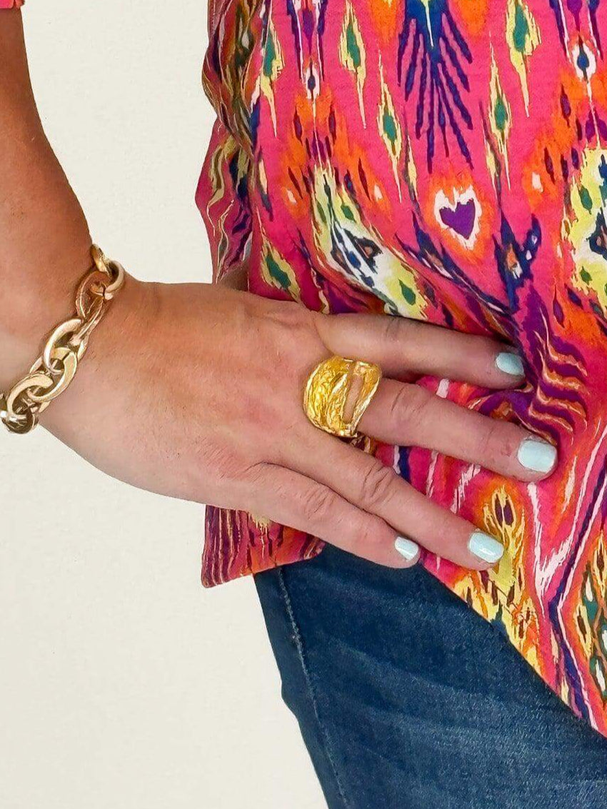 model wearing a gold open stretch ring hand on hip white background