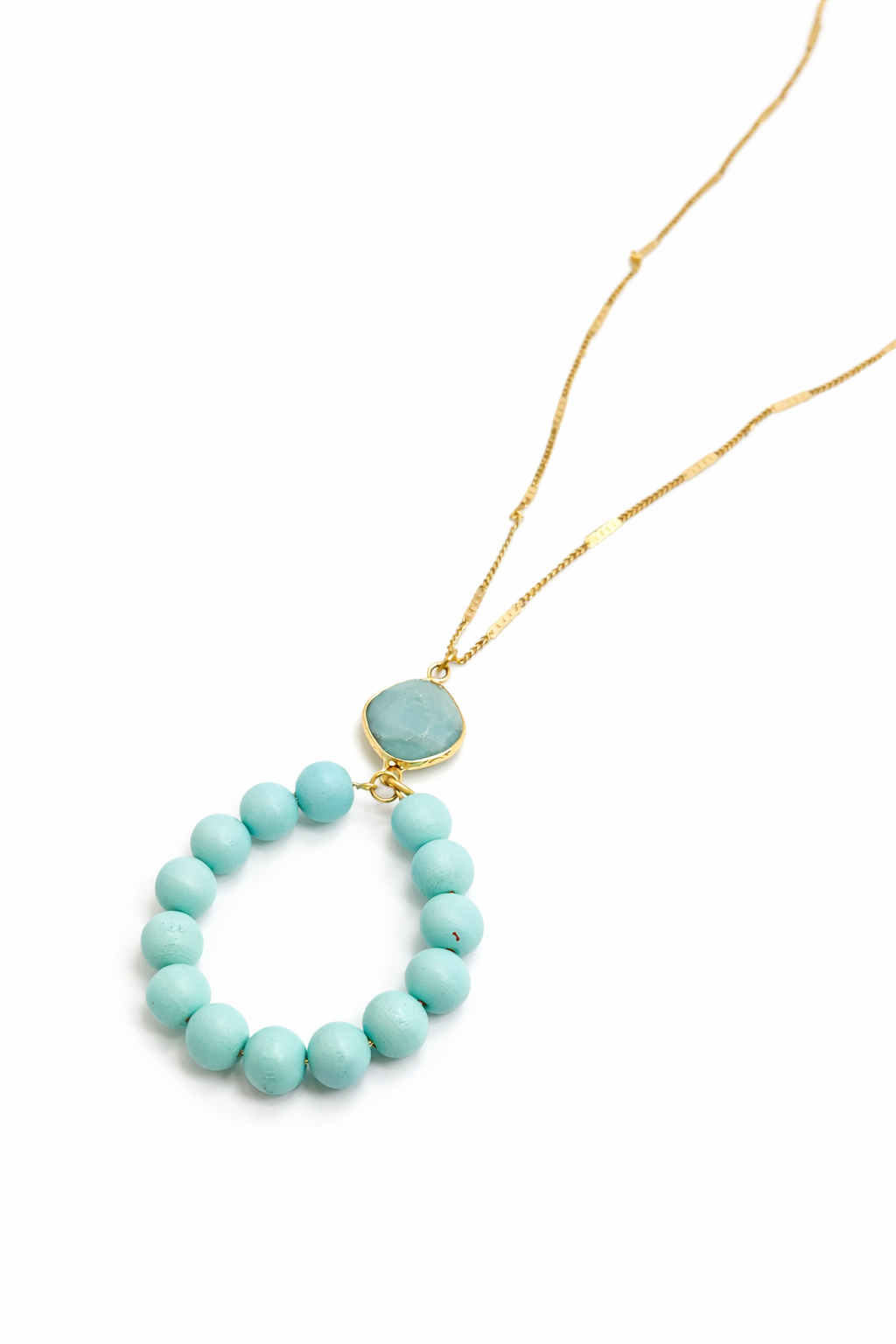 Turquoise beaded necklace with a gold clasp on a white background