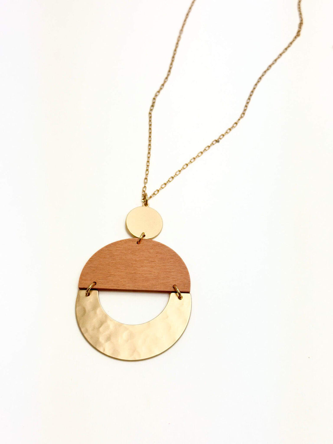 A gold-colored necklace with a light tan/gold pendant, displayed against a white background.