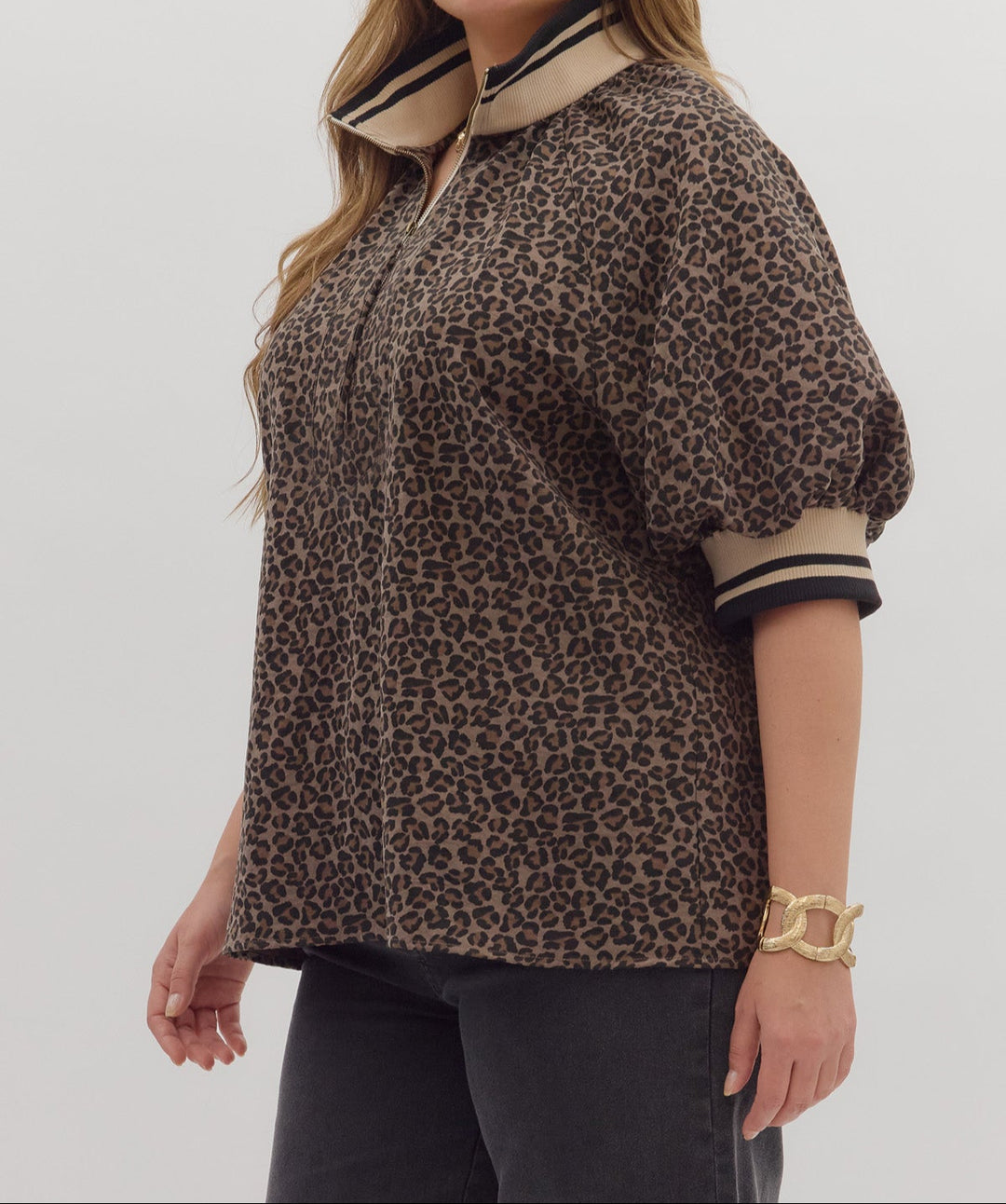 model wearing mocha brown leopard print top with striped details on white background