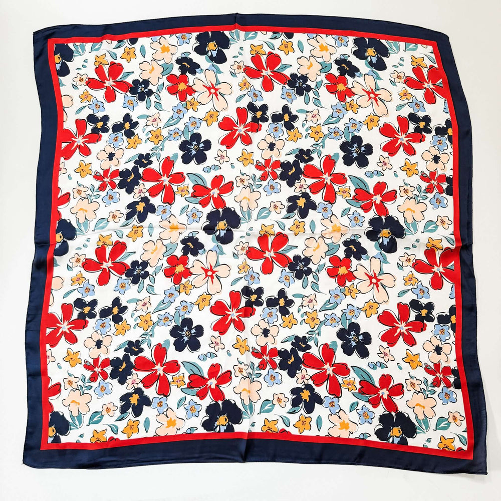 red white blue floral silk scarf laying on white background