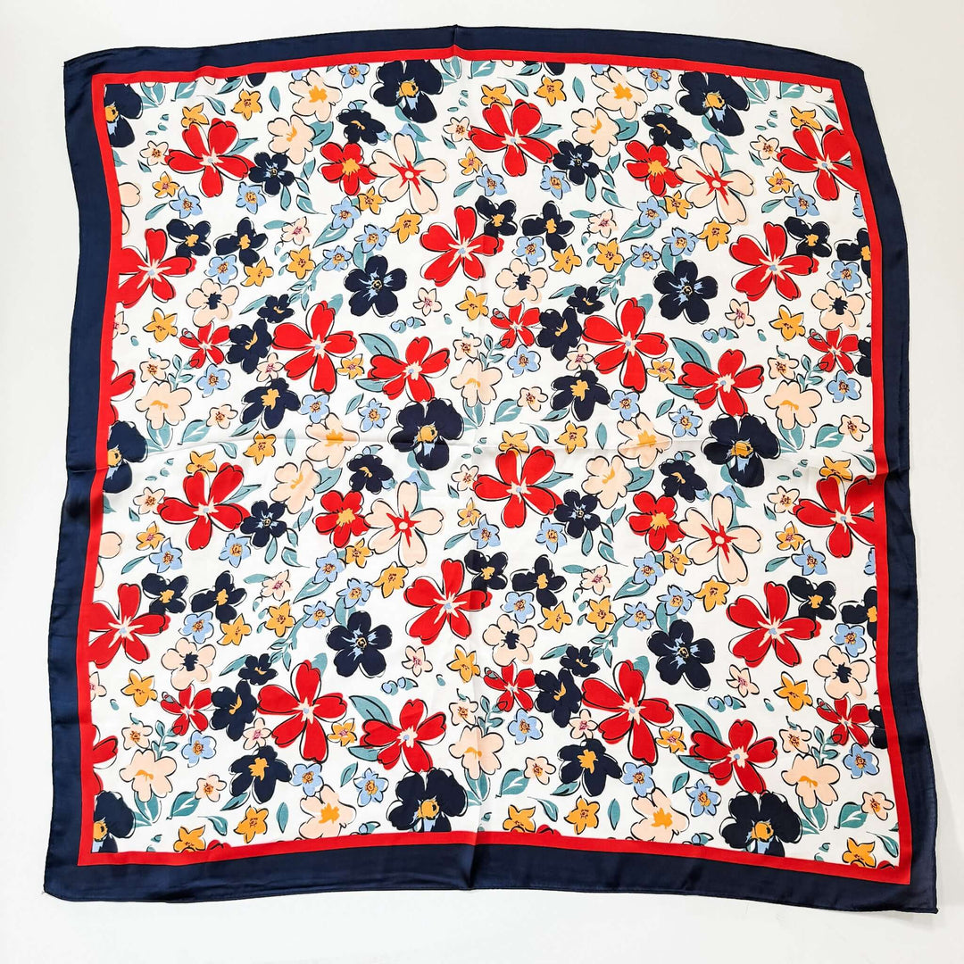 red white blue floral silk scarf laying on white background