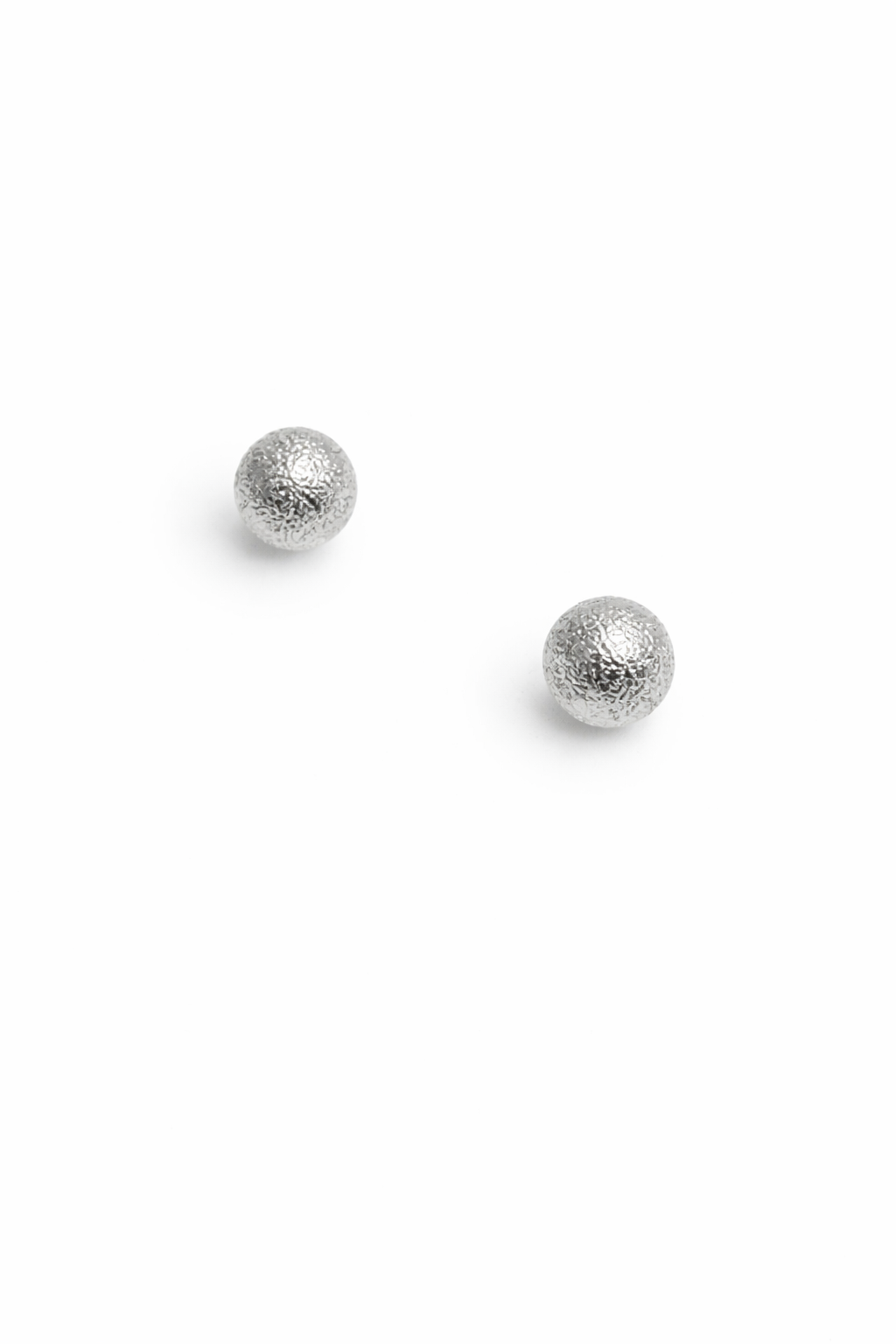 Two silver stud earrings on a white background