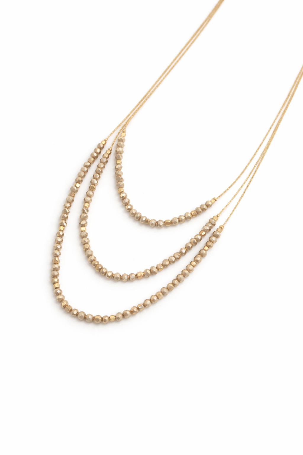 Two gold necklaces with beaded and chain designs on a white background