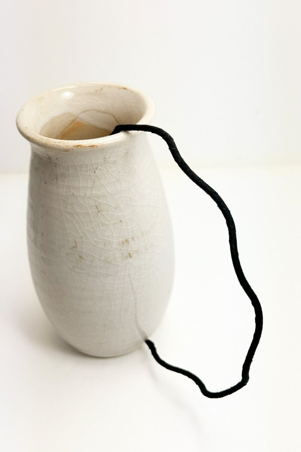 thin wavy headband in a vase on a white background