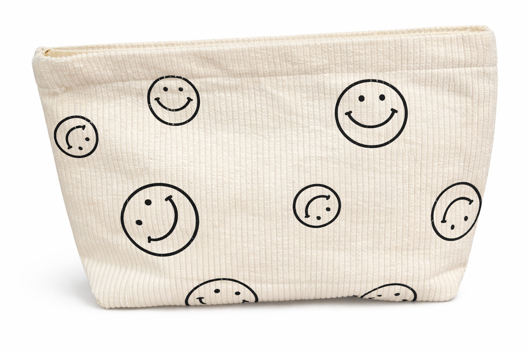 Beige pouch with black smiley face patterns on a white background