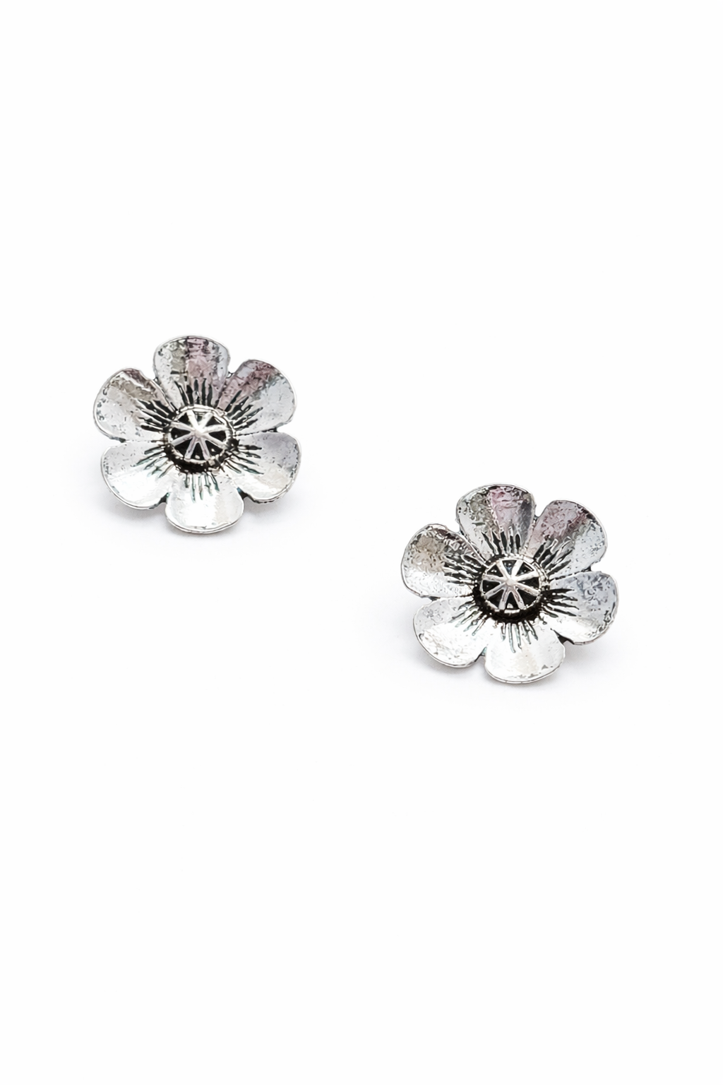 Pair of silver flower-shaped earrings on a white background