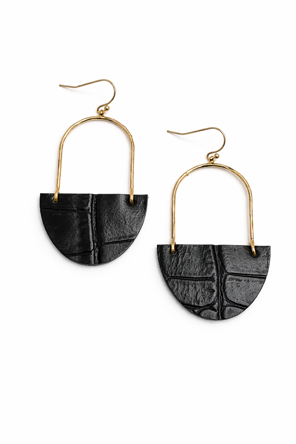 Pair of earrings with black half-circle designs and gold arches on a white background