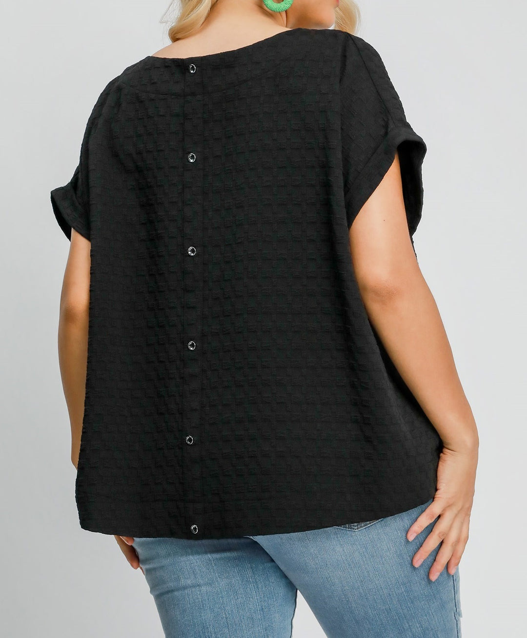 back of model wearing black textured top