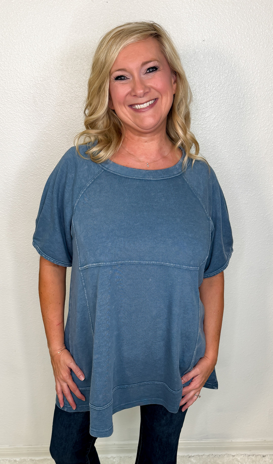 Woman wearing a blue sweater against a white background