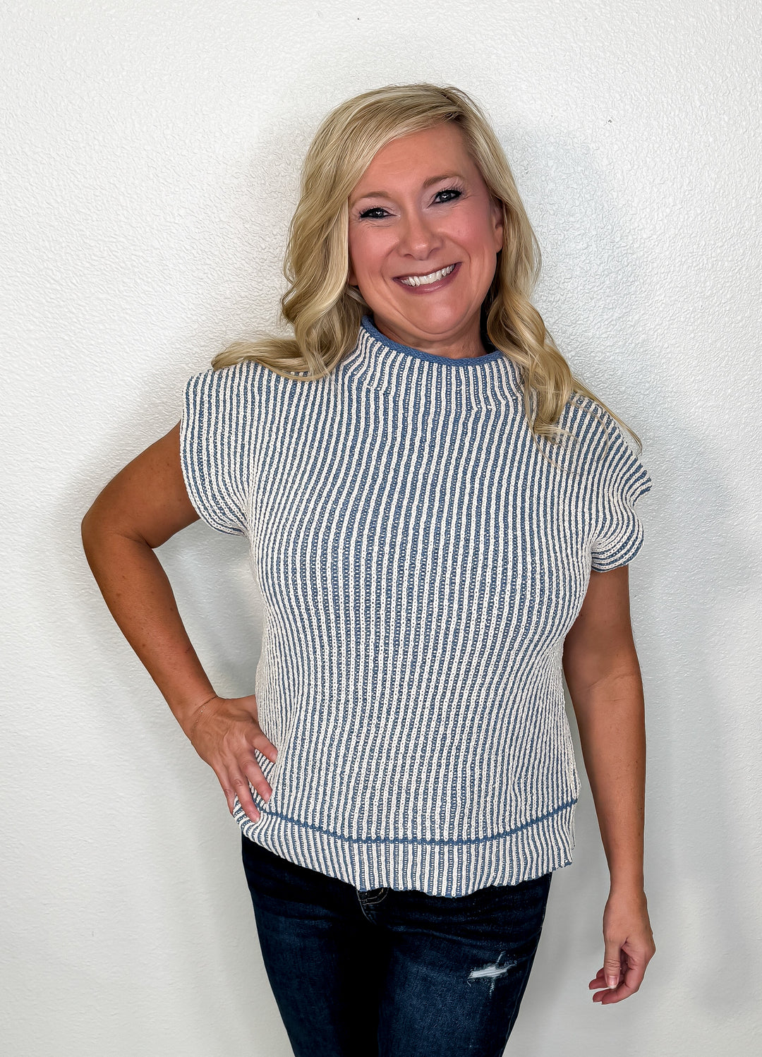 Woman wearing a striped shirt against a plain background