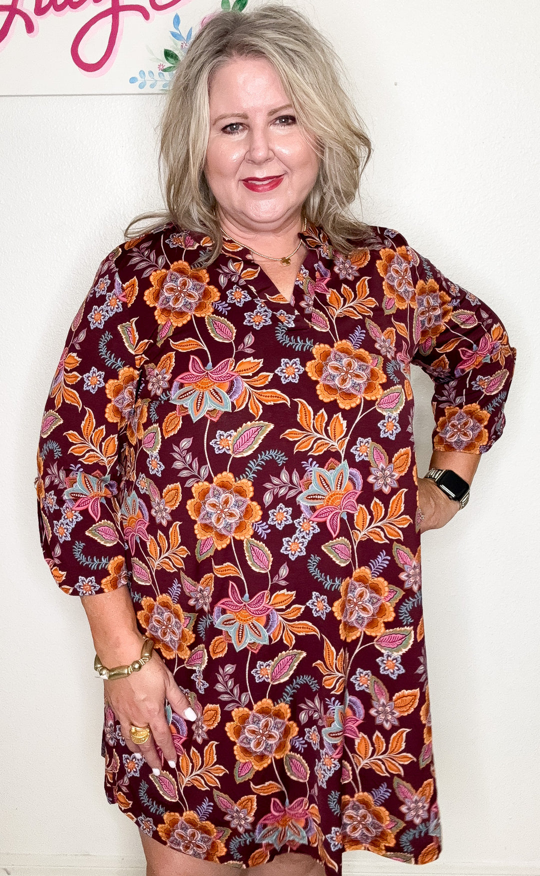 Woman wearing a floral dress with a white background