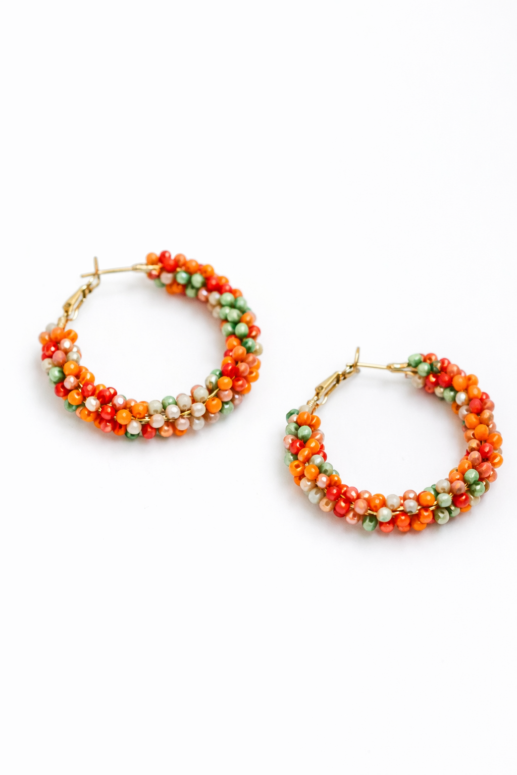 Pair of hoop earrings with colorful beads on a white background
