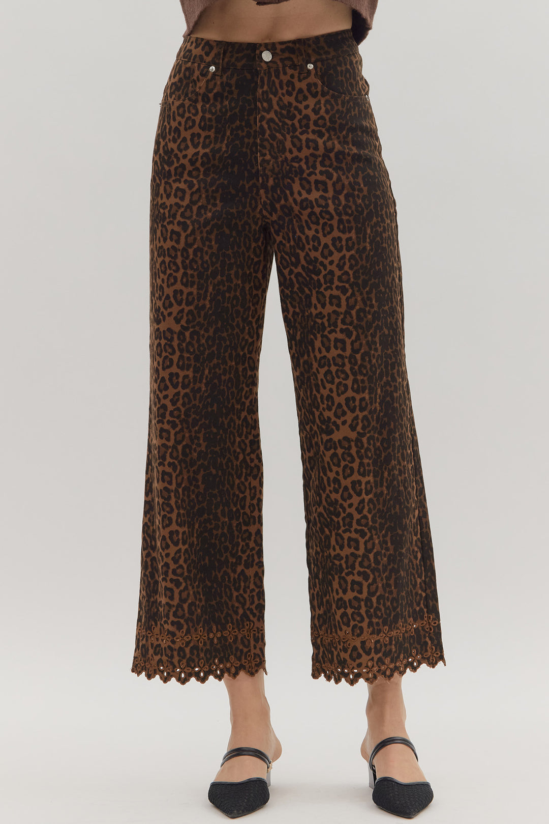 Leopard print pants with lace trim on a white background