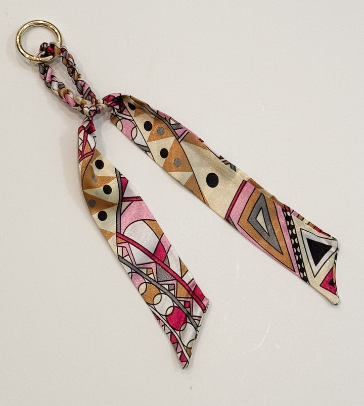 Colorful geometric patterned purse charm with a plain background