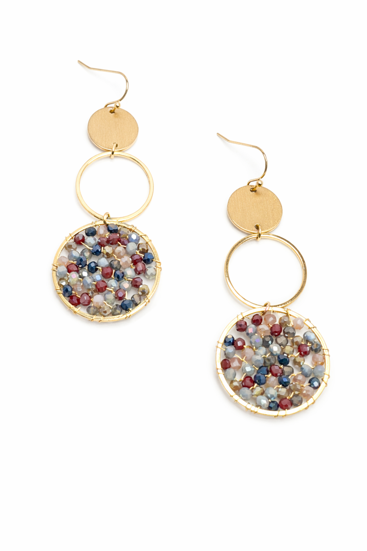 Gold earrings with multicolored bead embellishments on a white background