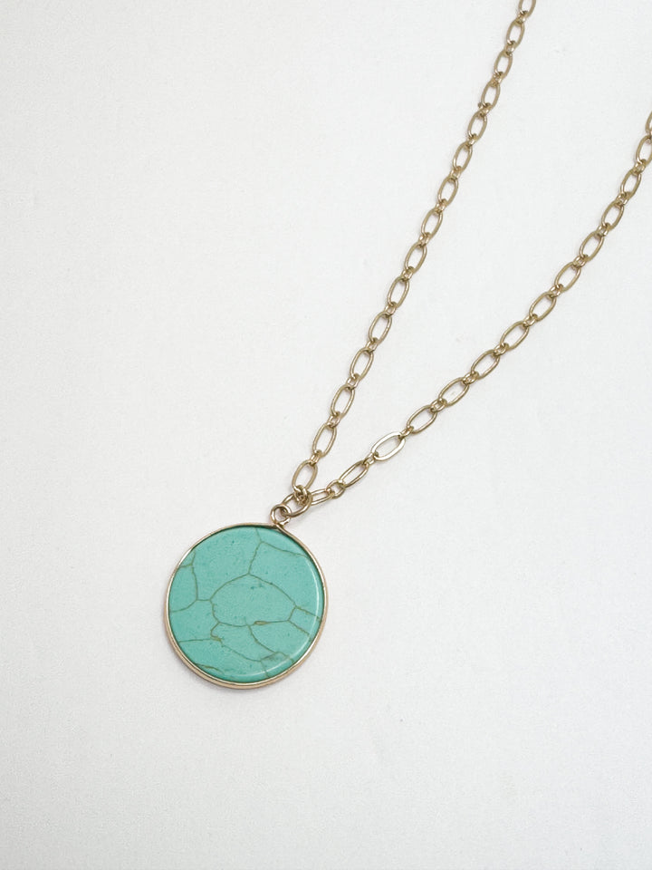 Necklace with a turquoise pendant on a white background