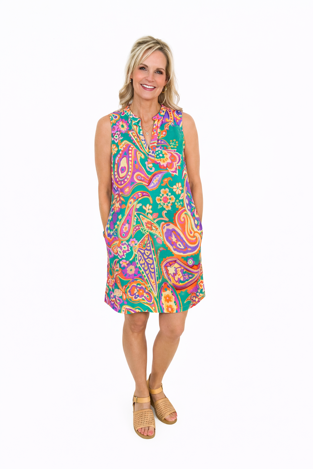 Woman wearing a colorful paisley dress on a white background
