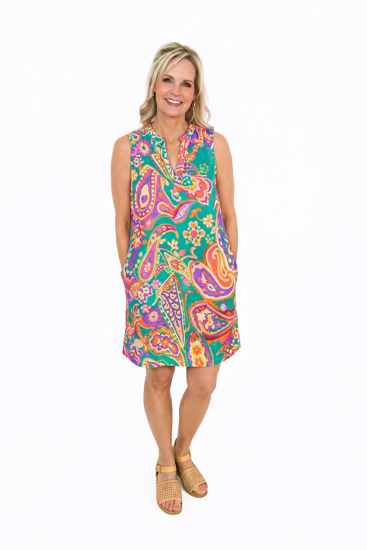 Woman wearing a colorful paisley dress on a white background