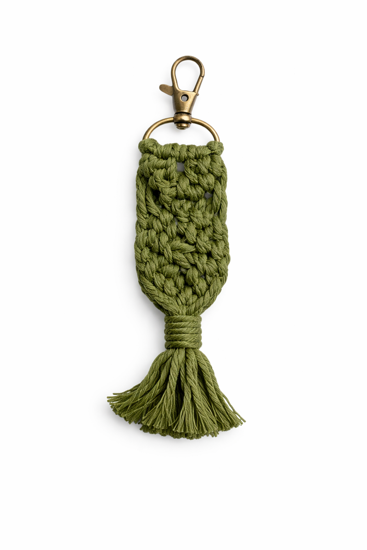 Green knitted keychain with a gold clasp on a white background