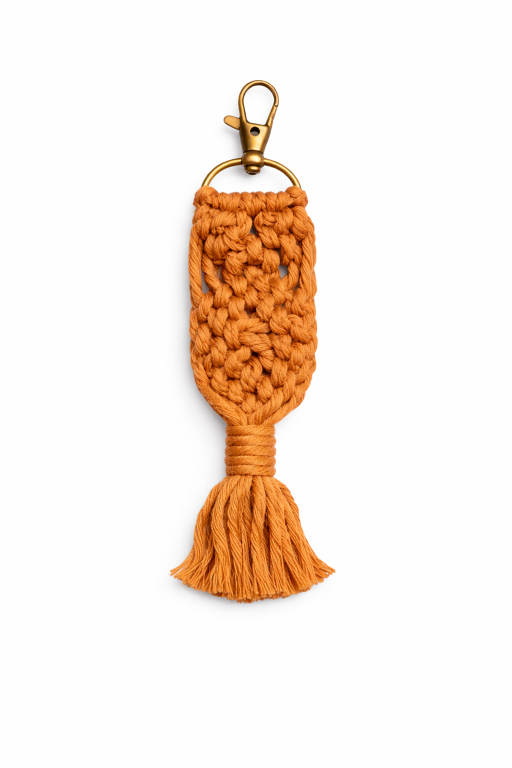 Orange knitted keychain with a tassel on a white background