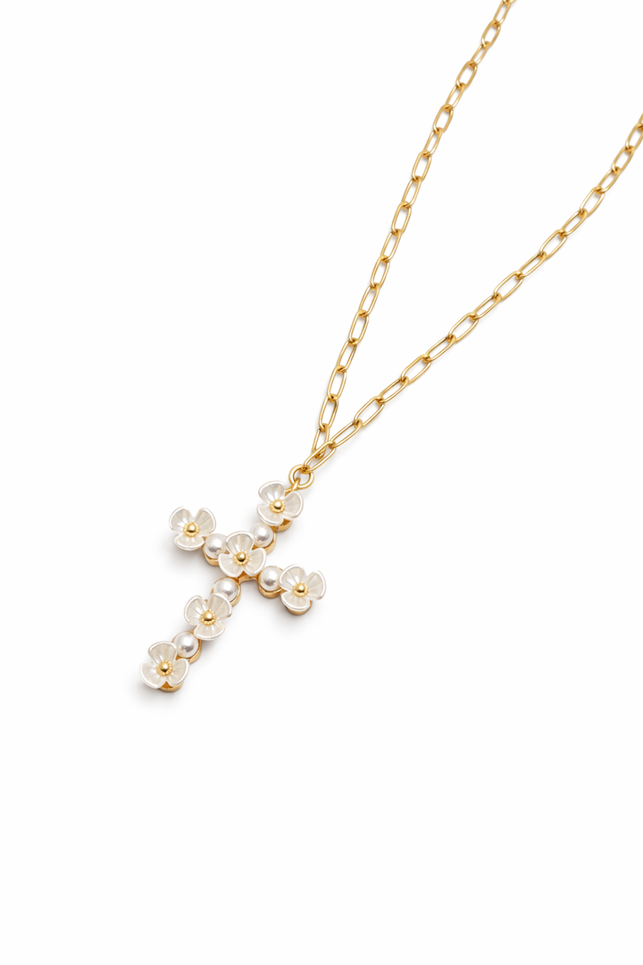 Gold necklace with a cross pendant on a white background