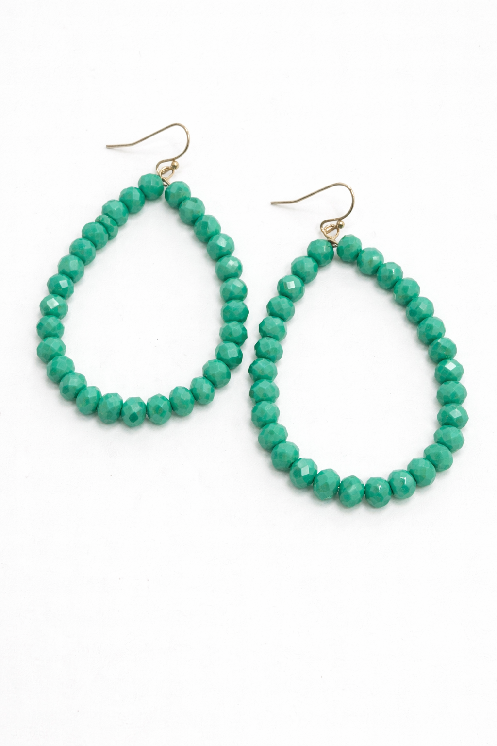 Pair of green beaded hoop earrings on a white background