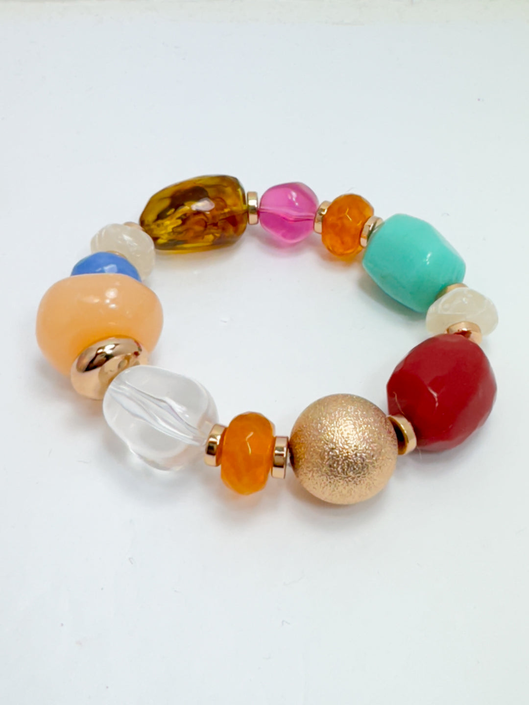 A colorful beaded bracelet with a variety of chunky beads in different colors including orange, blue, red, and gold-toned accents.
