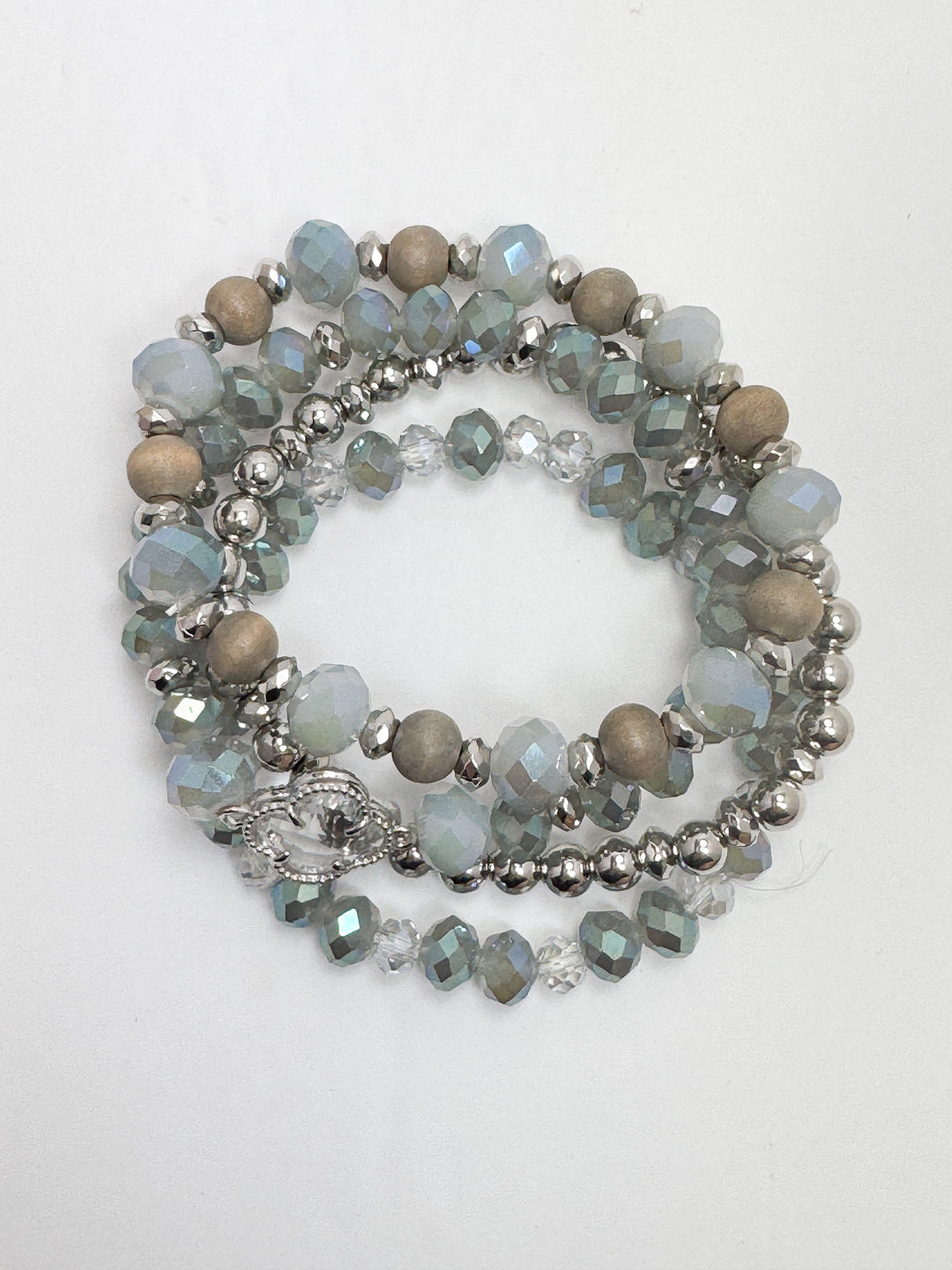 A set of iridescent blue beaded bracelets with various size beads and a metallic clasp.