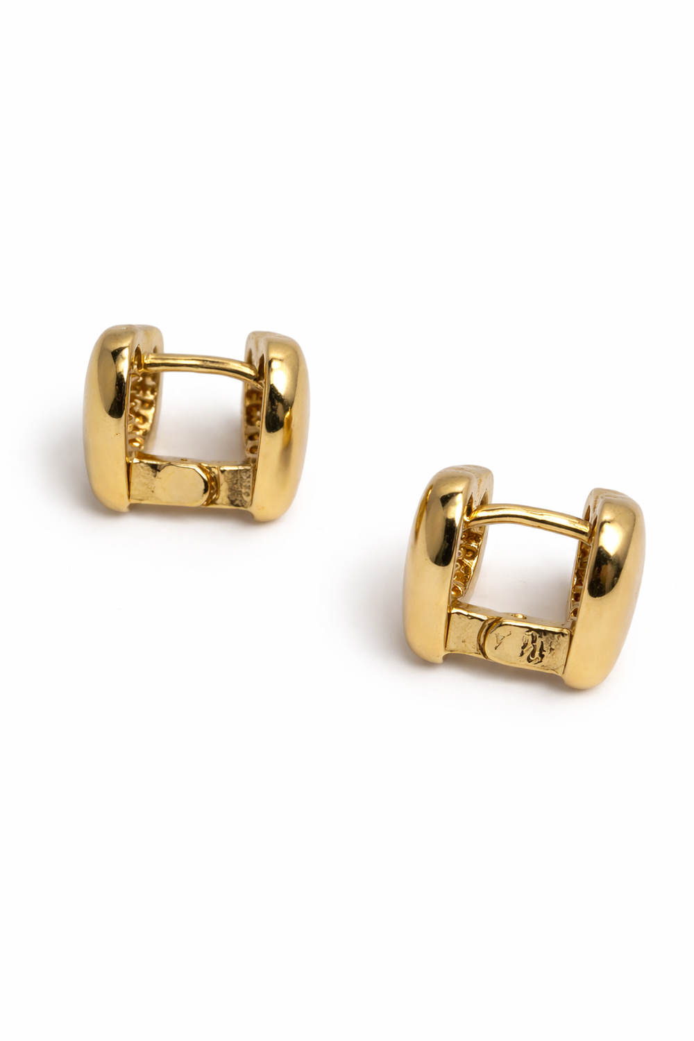 Pair of gold hoop earrings on a white background