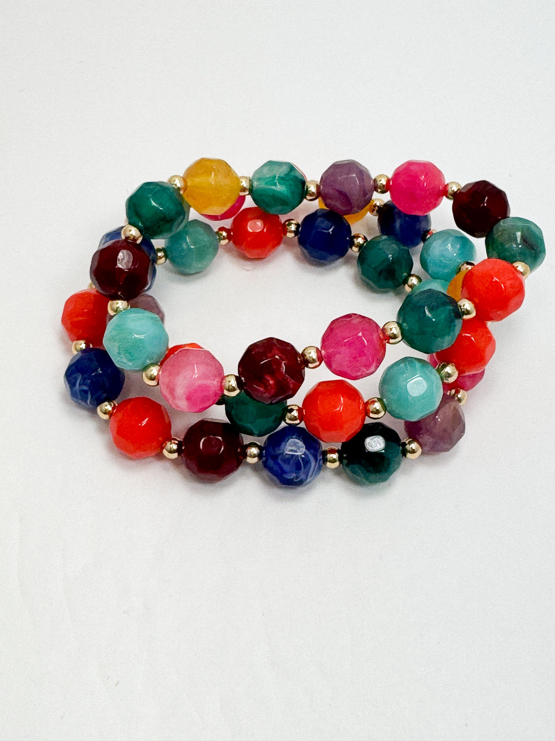 Multicolored beaded bracelets on a white background