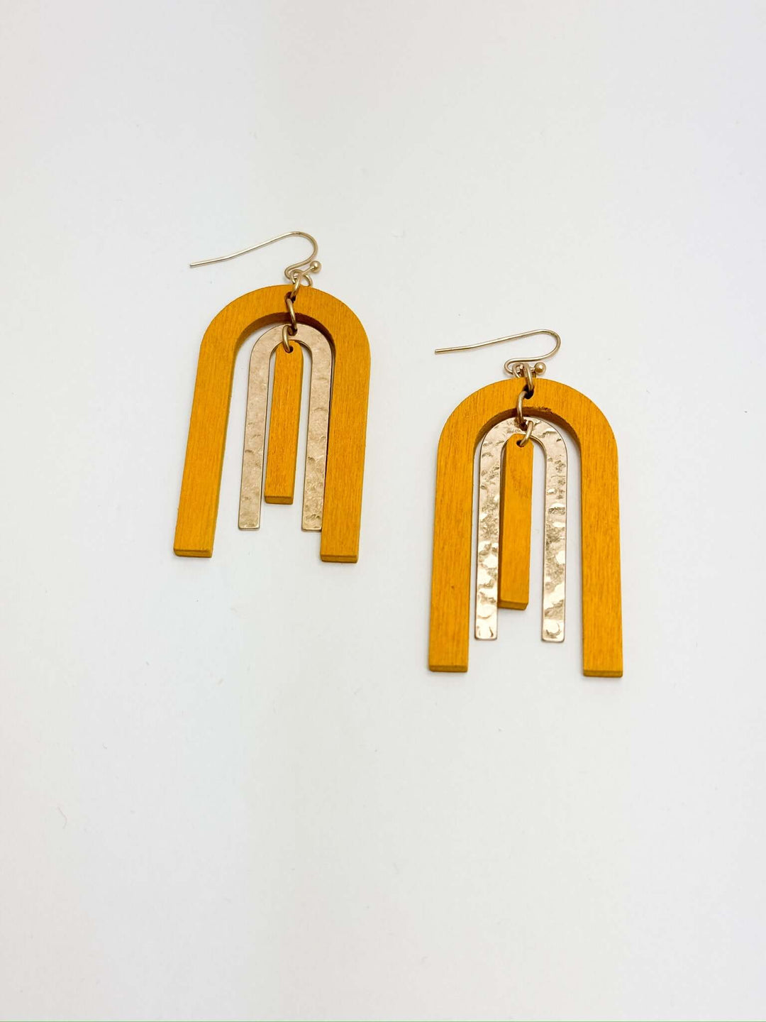 A pair of golden yellow arch earrings with gold accents, displayed against a white background.