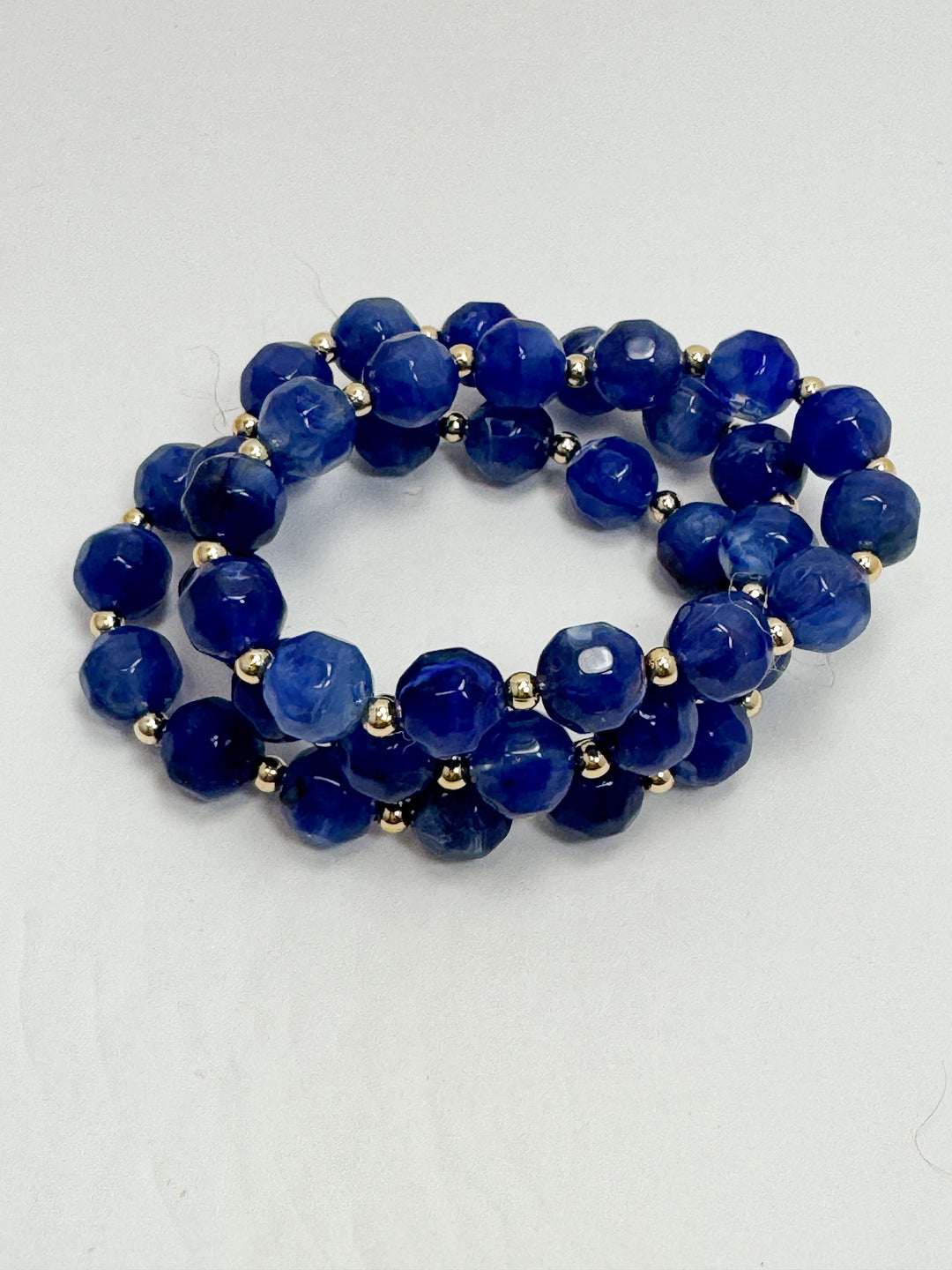 Blue beaded bracelet on a white background