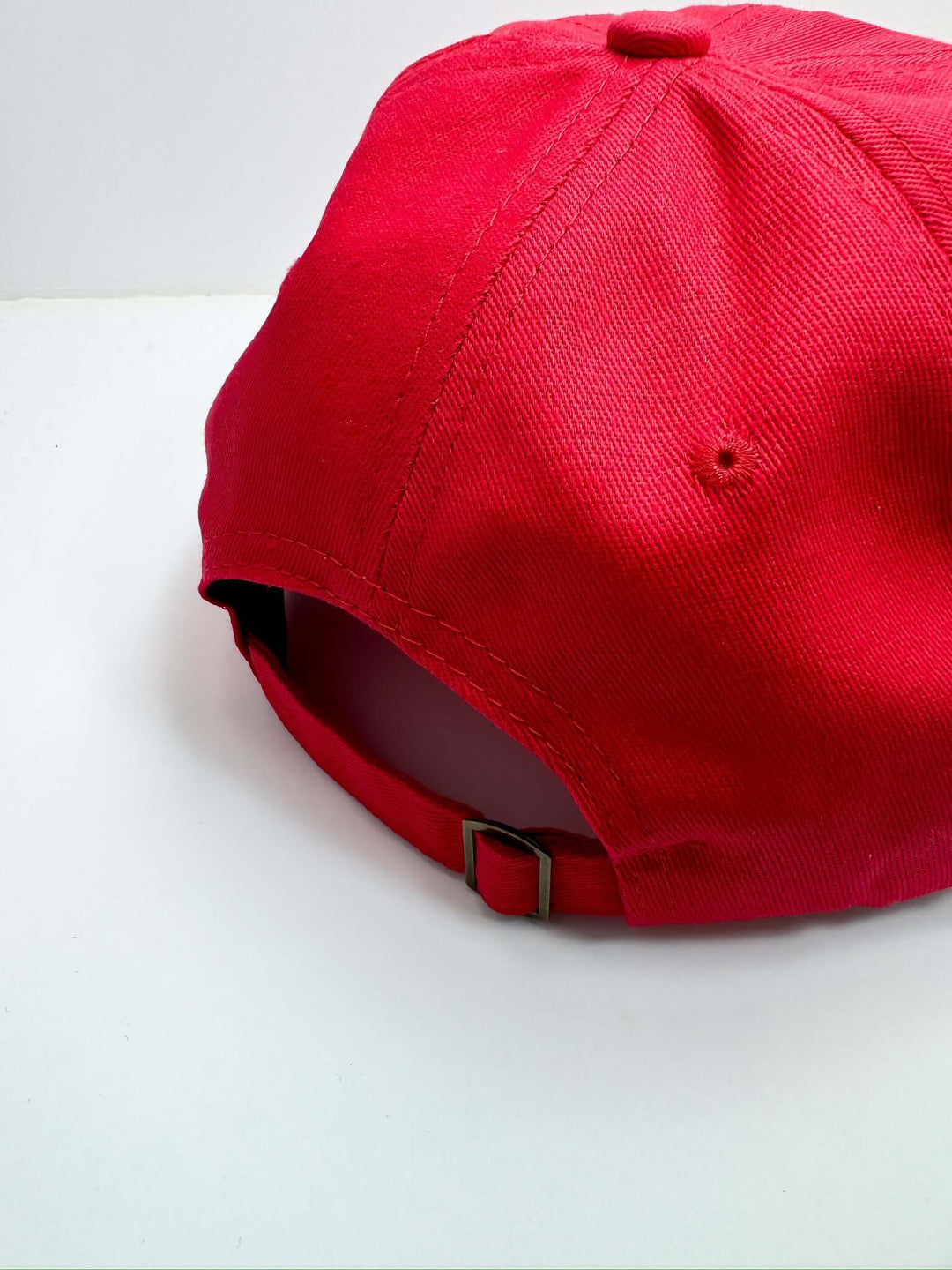 A red baseball cap with 'Game Day' text embroidered in white on the front.