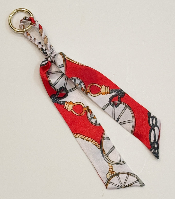 Purse charm with decorative design on a white background
