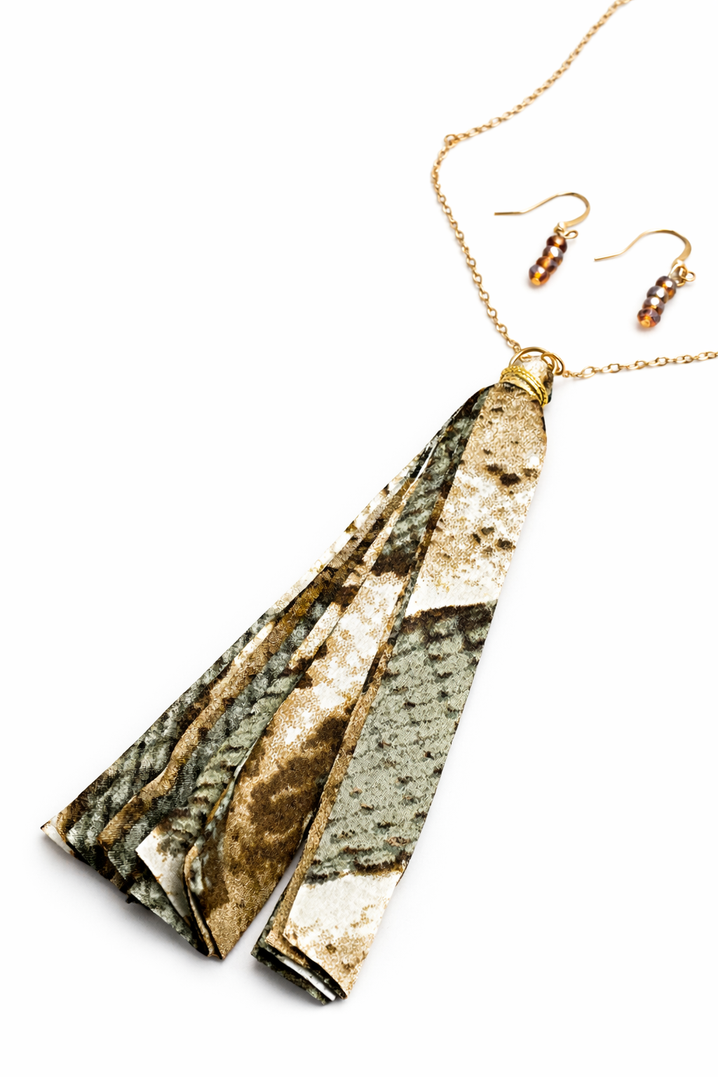 Jewelry set with a long pendant and matching earrings on a white background