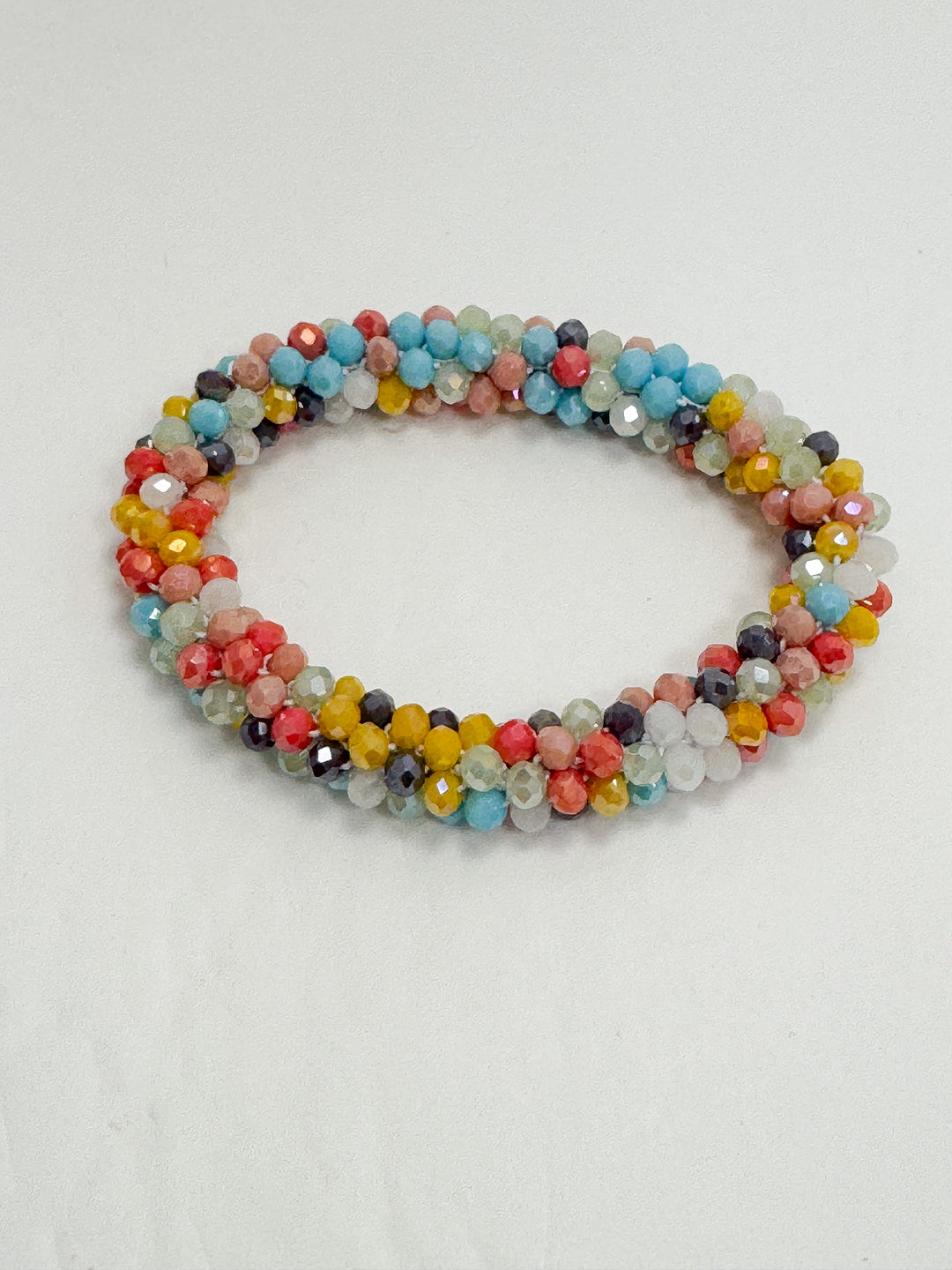 Multicolored beaded bracelet on a light gray background
