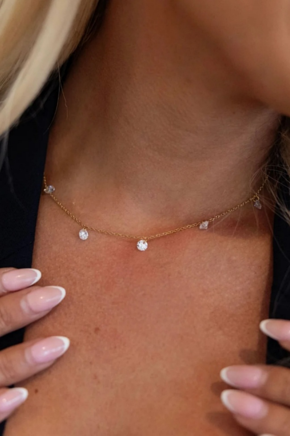 model wearing a dainty gold and crystal necklace