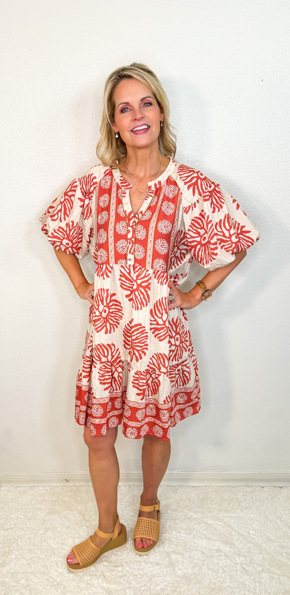model wearing a terracotta and cream print dress
