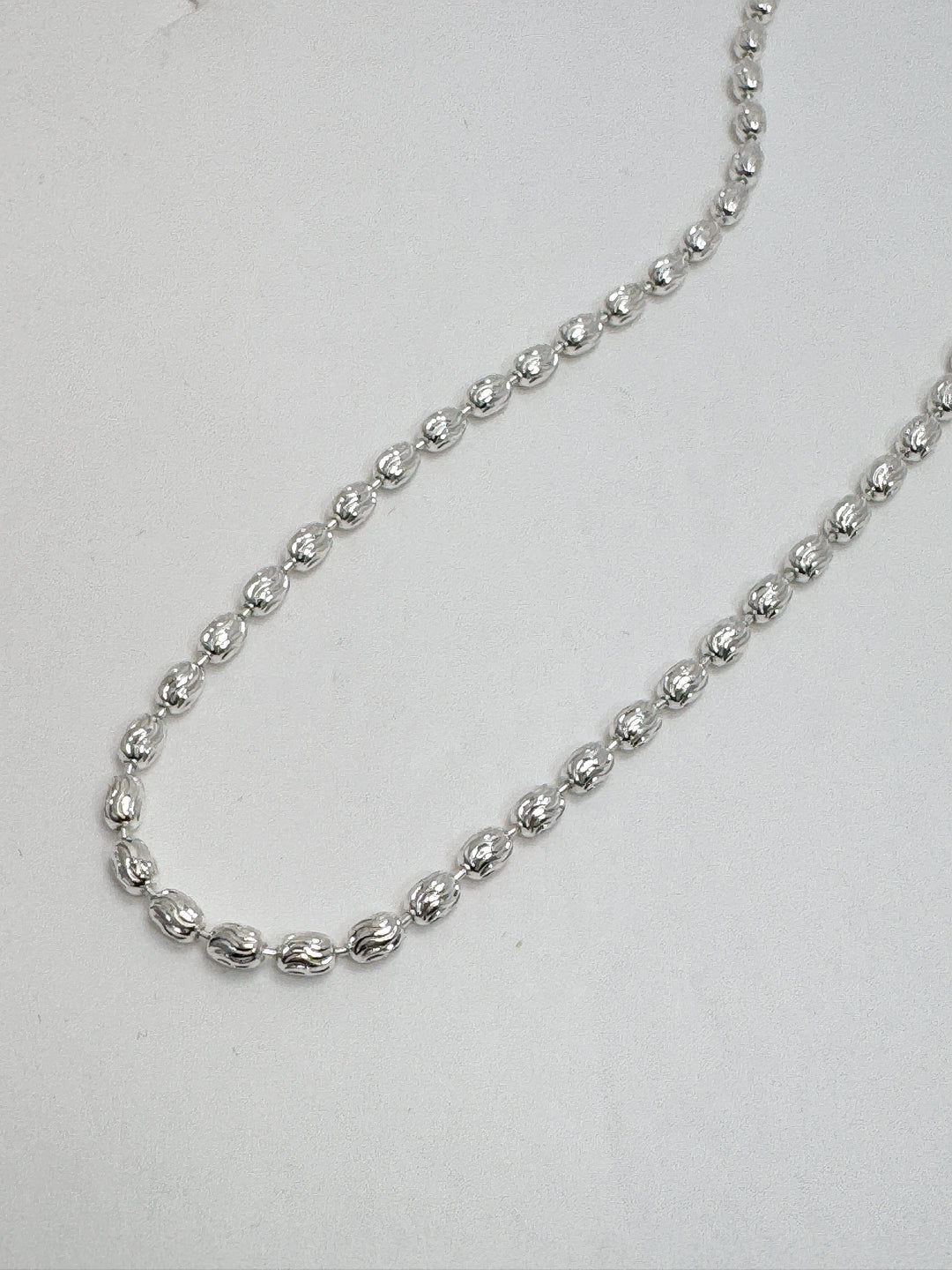 Silver chain necklace on a white background